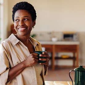 Smiling woman enjoying coffee at home