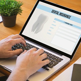 Patient filling out dental insurance form on computer