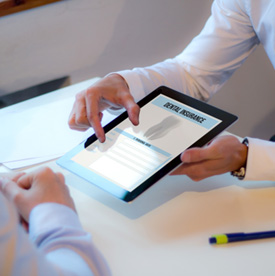 Two people looking at dental insurance information on a tablet