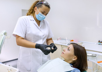 a patient and her dentist chatting about dental implants