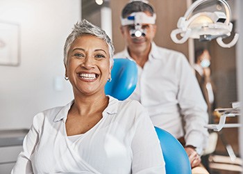 Middle-aged woman smiling while using dental insurance in Londonderry