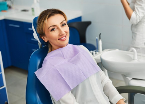 Woman smiling while sitting in treatment chair