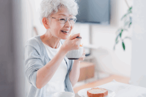 a patient with dentures smiling while eating