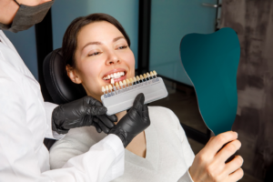 a person smiling into a handheld mirror