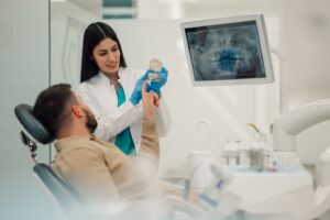 Dentist discussing dental implants with male patient
